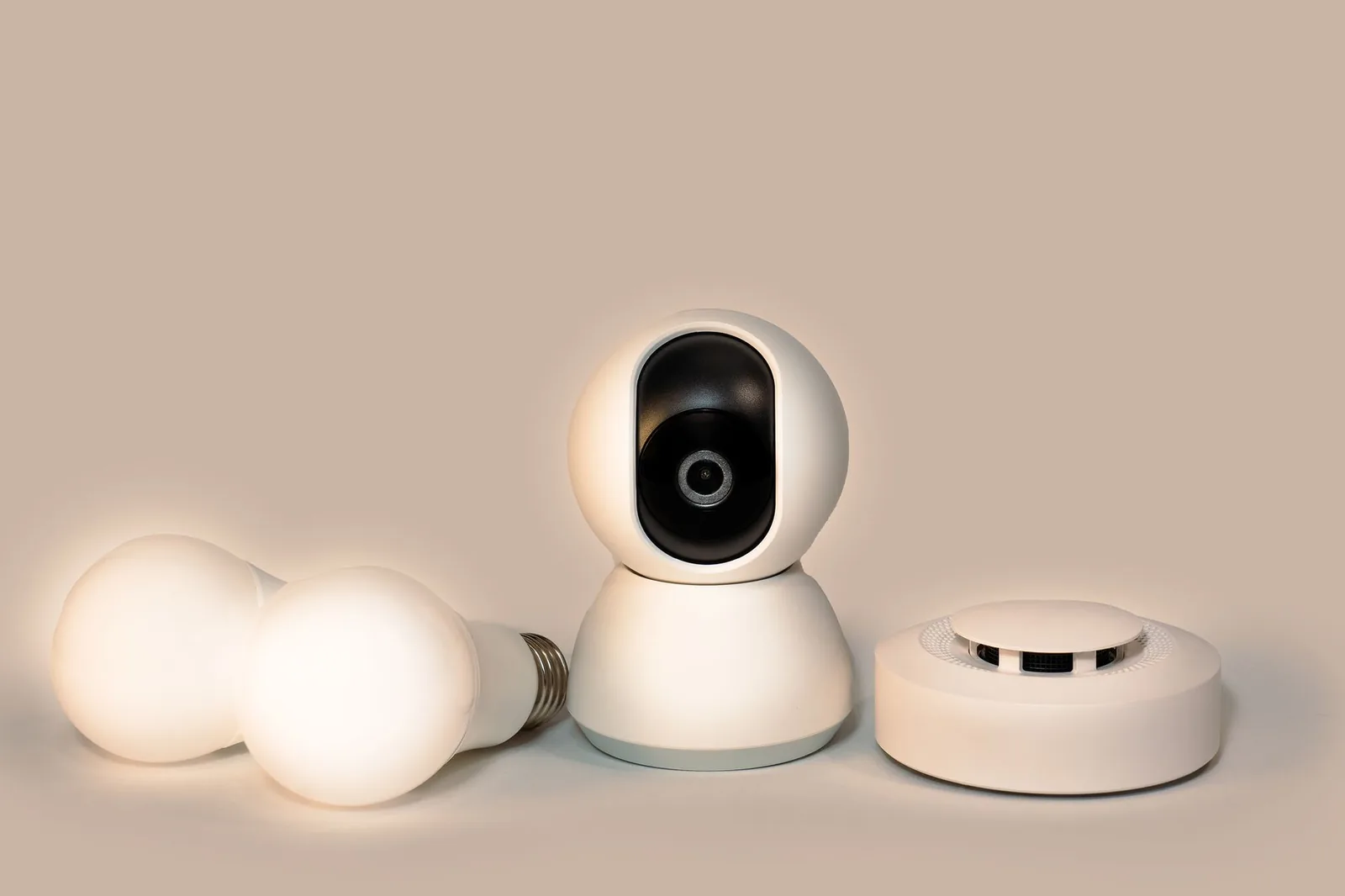 A modern smoke detector mounted alongside other smart home detection devices.